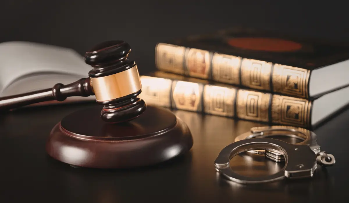 Court gavel, law books, and handcuffs representing burglary in Naperville defense services by experienced attorneys.