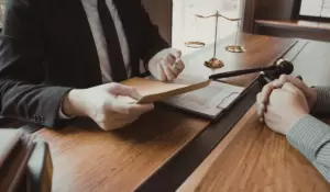 Attorney reviewing legal documents with client accused of sexual assault in Illinois